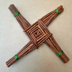 celtic cross made from brown willow, arms of the cross are bound with green wire